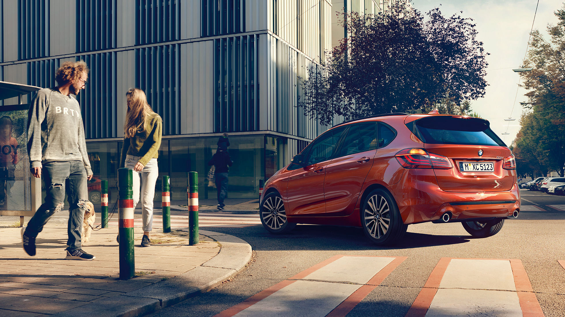 Driving dynamics BMW 2 Series Active Tourer Driving dynamics BMW 2 Series Active Tourer 220i 2018 F45 Sunset Orange metallic three-quarter rear view