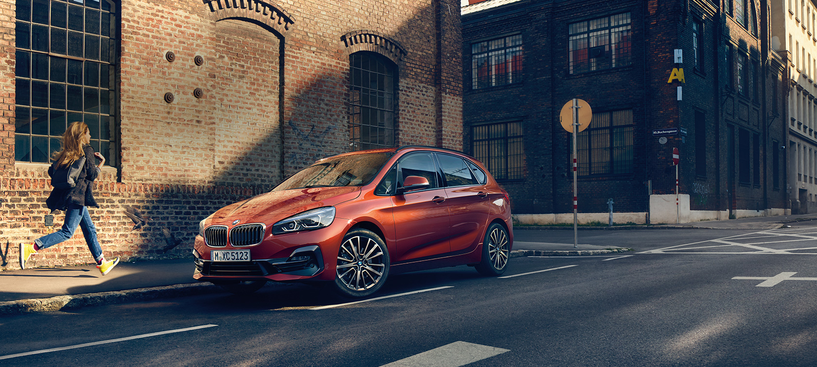 BMW 2 Series Active Tourer F45 Facelift 2018 Sunset Orange metallic three-quarter front view parking on the road
