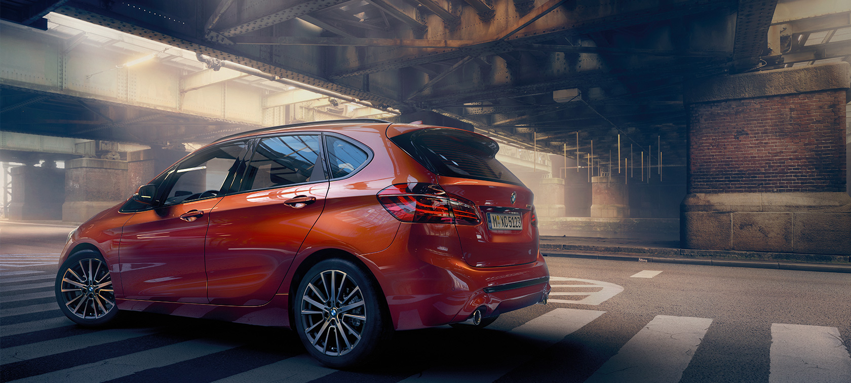 Side view BMW 2 Series Active Tourer BMW 2 Series Active Tourer F45 Facelift 2018 Sunset Orange metallic side view standing in hall