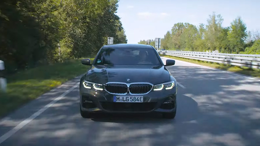 BMW plug-in hybrid driving on road BMW plug-in hybrid front view driving on road