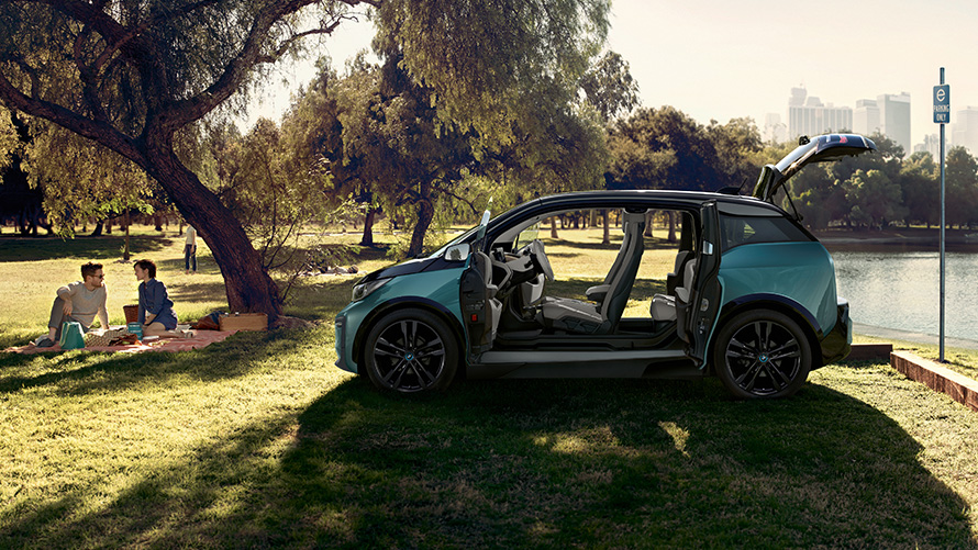BMW i3 2018 in park BMW i3 I01 2018 Jucaro beige with Frozen Grey metallic highlight side view with open doors in park